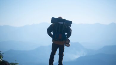 man traveler with backpack mountaineering travel lifestyle concept