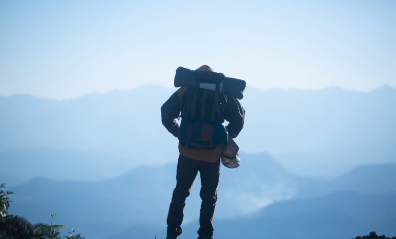 man traveler with backpack mountaineering travel lifestyle concept